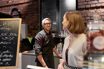 Image showing happy bartenders at cafe or coffee shop counter