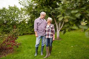 Image showing happy senior couple hugging at summer garden