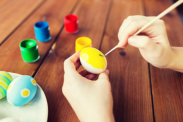 Image showing close up of woman hands coloring easter eggs