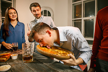 Image showing Group of friends enjoying evening drinks with beer