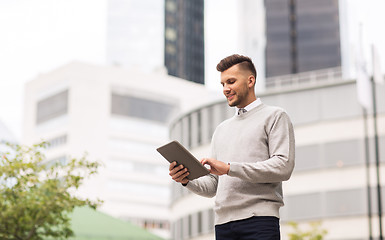 Image showing happy man with tablet pc computer in city