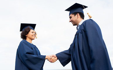 Image showing happy students or bachelors greeting each other