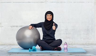 Image showing muslim woman in hijab with fitness ball and bottle