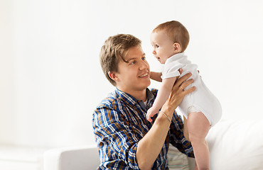 Image showing happy young father with little baby at home