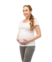 Image showing happy pregnant woman touching her big belly