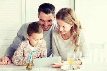 Image showing happy family with tablet pc at restaurant