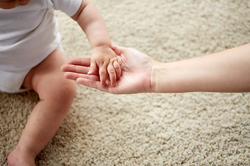 Image showing close up of little baby and mother hands