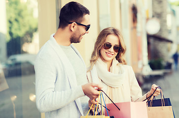 Image showing happy couple with shopping bags on city street