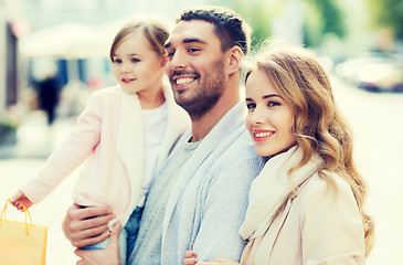 Image showing happy family with child and shopping bags in city