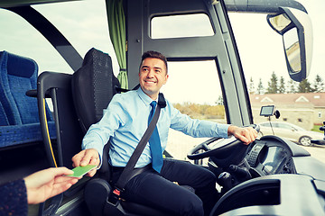 Image showing bus driver taking ticket or card from passenger