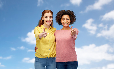 Image showing happy smiling women showing thumbs up