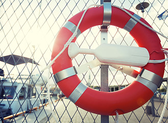 Image showing lifebuoy over moored boats on pier