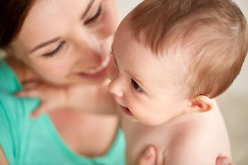 Image showing happy young mother with little baby at home