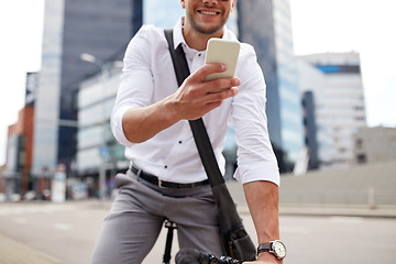 Image showing man with smartphone and fixed gear bike on street