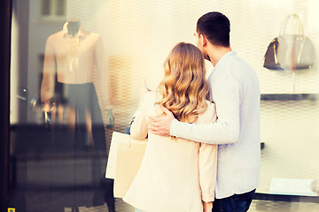 Image showing couple with shopping bags looking at shop window