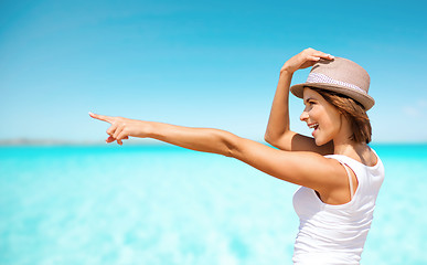 Image showing happy young woman in hat on summer beach