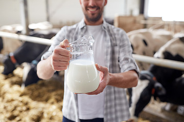 Image showing man or farmer with cows milk on dairy farm