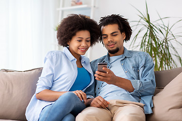 Image showing happy couple with smartphones at home