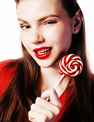 Image showing young pretty brunette girl with red candy posing on white backgr