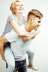 Image showing young pretty teenage couple, hipster guy with his girlfriend happy smiling and hugging isolated on white background, lifestyle people concept