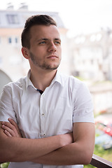 Image showing man standing at balcony