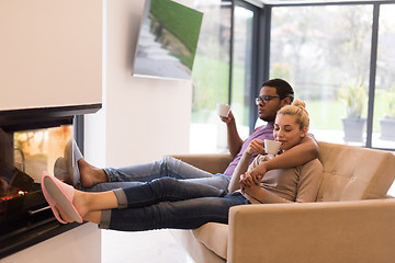 Image showing Young multiethnic couple  in front of fireplace