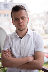 Image showing man standing at balcony