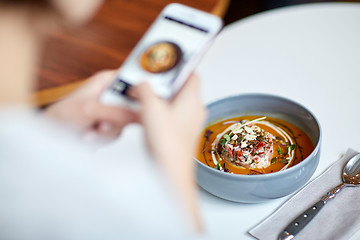 Image showing woman with smartphone photographing food at cafe