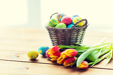 Image showing close up of easter eggs in basket and flowers