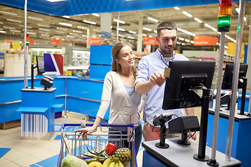 Image showing couple buying food at grocery store cash register