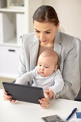 Image showing businesswoman with baby and tablet pc at office