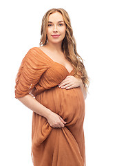 Image showing happy pregnant woman touching her big belly