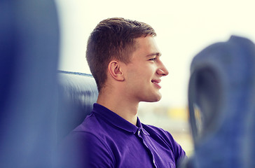 Image showing happy young man sitting in travel bus