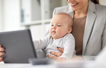 Image showing businesswoman with baby and tablet pc at office