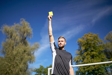 Image showing referee on football field showing yellow card