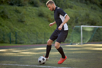 Image showing soccer player playing with ball on football field