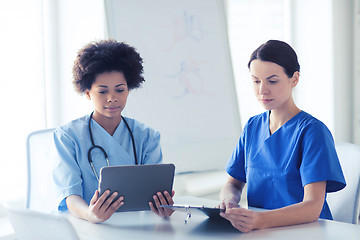 Image showing doctors with tablet pc meeting at hospital