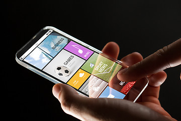 Image showing close up of hand with apps on smartphone