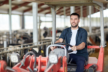 Image showing man or farmer driving tractor at farm