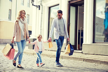 Image showing happy family with child and shopping bags in city