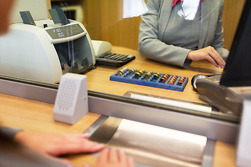 Image showing clerk counting cash money at bank office