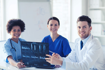 Image showing group of happy doctors discussing x-ray image