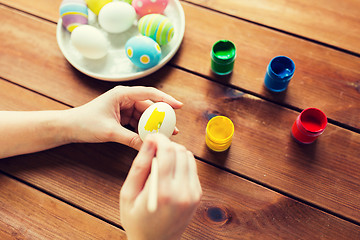 Image showing close up of woman hands coloring easter eggs