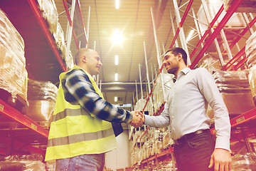 Image showing worker and businessmen with clipboard at warehouse