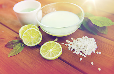 Image showing close up of body lotion, cream and salt on wood