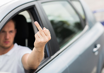 Image showing close up of man driving car showing middle finger