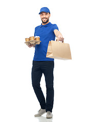 Image showing happy delivery man with coffee and food in bag
