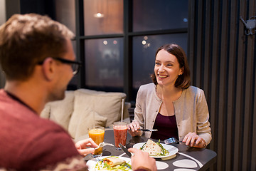 Image showing happy couple eating dinner at vegan restaurant