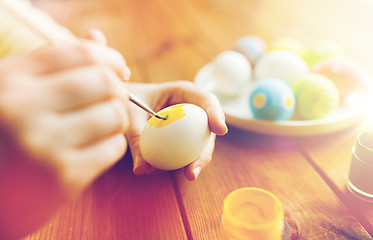 Image showing close up of woman hands coloring easter eggs