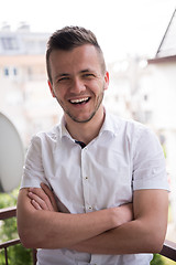 Image showing man standing at balcony